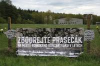 Banner am Zaun der Schweinemastanlage: "Die Schweinefarm auf dem Gelände des Roma-Konzentrationslagers Lety abreißen"